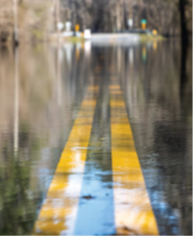 Close up of double lines on a very wet roadway.